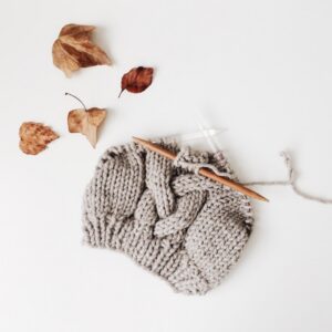 Chunky grey knitted wool beanie with needles