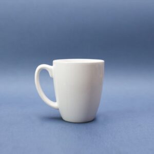 Plain white stoneware mug on a blue background