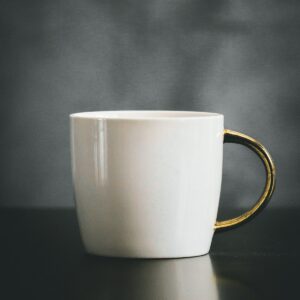 White porcelain mug with a gold handle