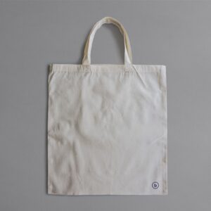 Natural cotton canvas tote bag on a grey background
