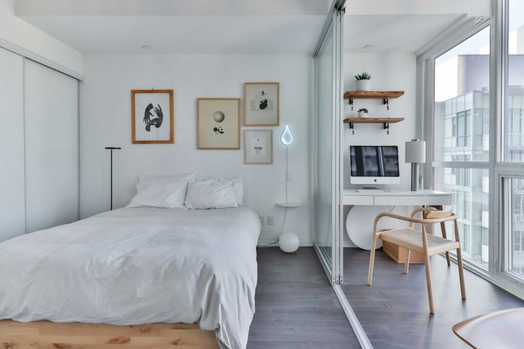 Light-filled bedroom with a study desk and city-facing window
