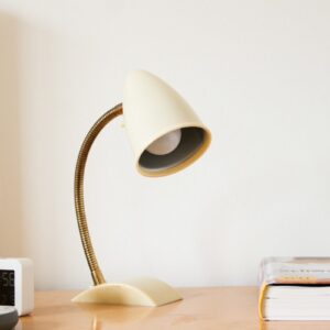 Cream vintage gooseneck desk lamp on a wooden desk